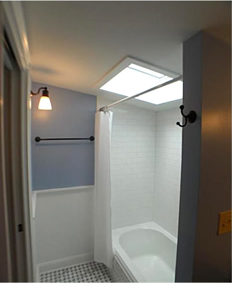 We installed a Kohler cast iron soaking tub with a subway tile surround.  And as you can see, we also installed a 30" X 30" skylight that adds a lot of light to this small space. 
